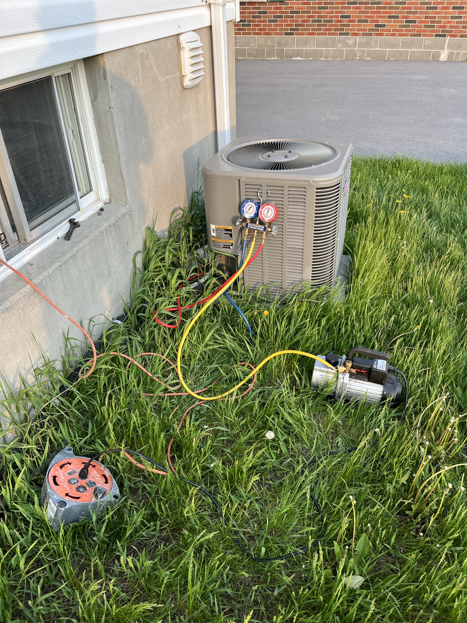 AC refrigerant service and pressure testing on residential central air unit in Toronto