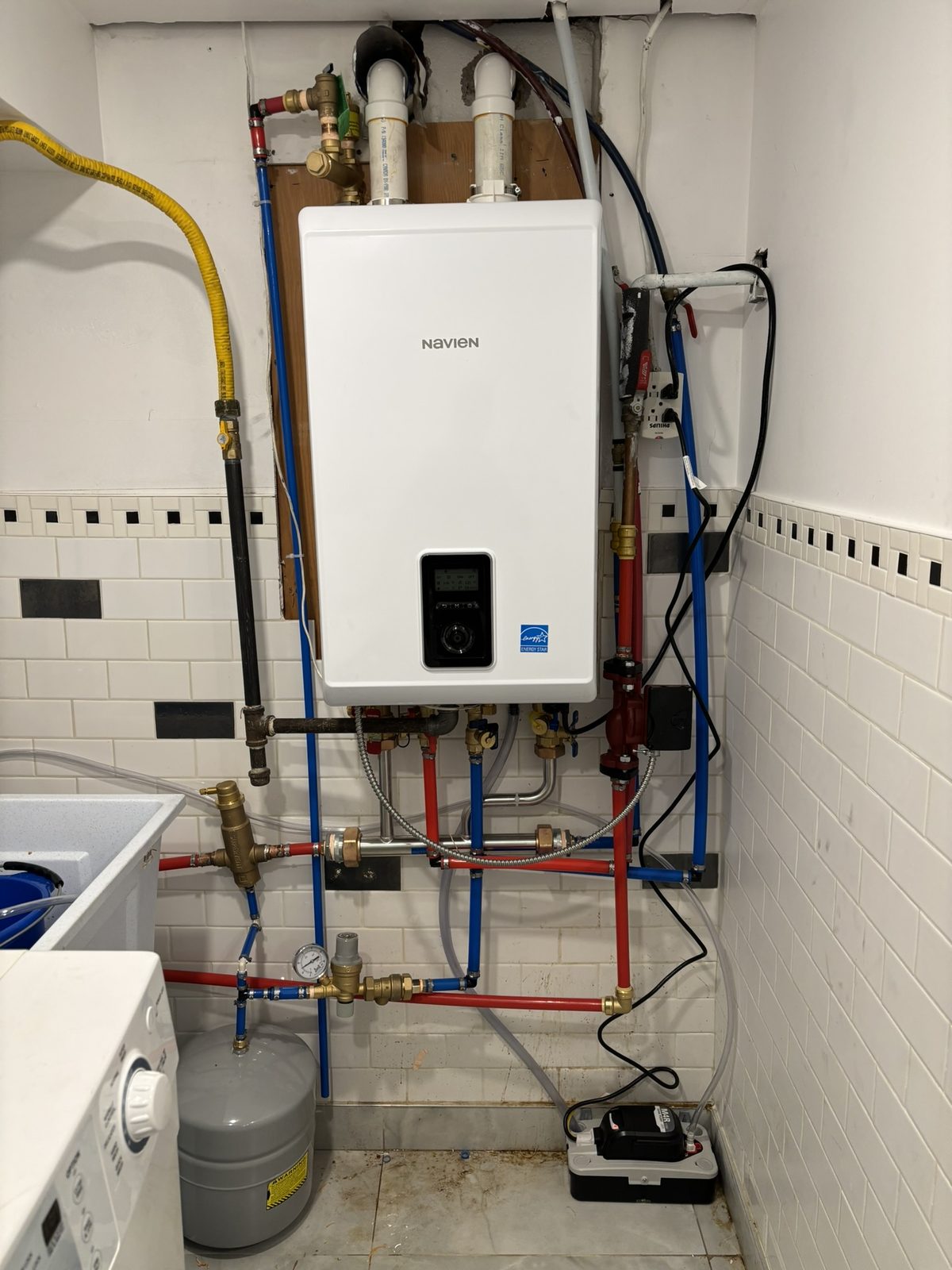PEX water lines and isolation valves connected to a Navien tankless water heater in Toronto